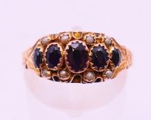 A 9 ct gold, garnet and seed pearl ring, hallmarked for Chester 1907?. Ring size P.