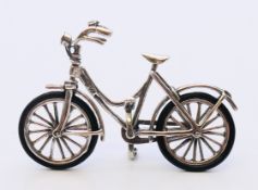 A silver miniature bicycle. 6.5 cm x 4 cm.