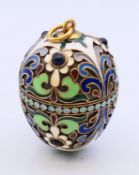 An egg pendant, bearing Russian marks. 4 cm high.