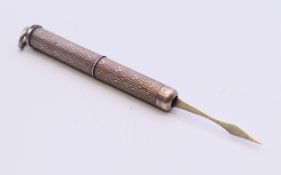 A silver tooth pick. 7 cm long extended.