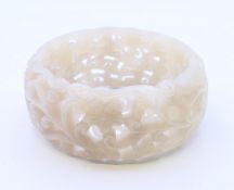 A pierced celadon jade bangle. 6 cm inner diameter, 7.7 cm outer diameter, 3 cm high.