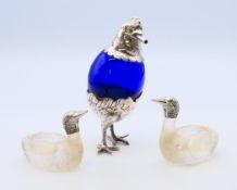 A Continental novelty table lighter formed as a chicken smoking a cigar;