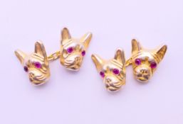 A pair of cufflinks in the form of dogs head, bearing Russian marks. 1.5 cm high.