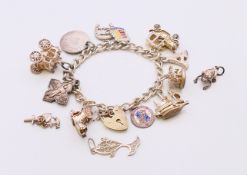A silver charm bracelet with charms and three loose charms. Bracelet approximately 18 cm long.