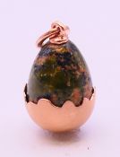 A 14 ct gold egg pendant, bearing Russian marks. 2.5 cm high including suspension loop.