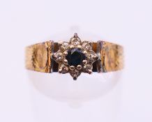 An 18 ct gold, diamond and sapphire ring. Ring size O.
