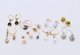 A quantity of various gold and other earrings.