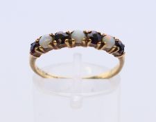 A 9 ct gold opal and garnet ring. Ring size O/P.