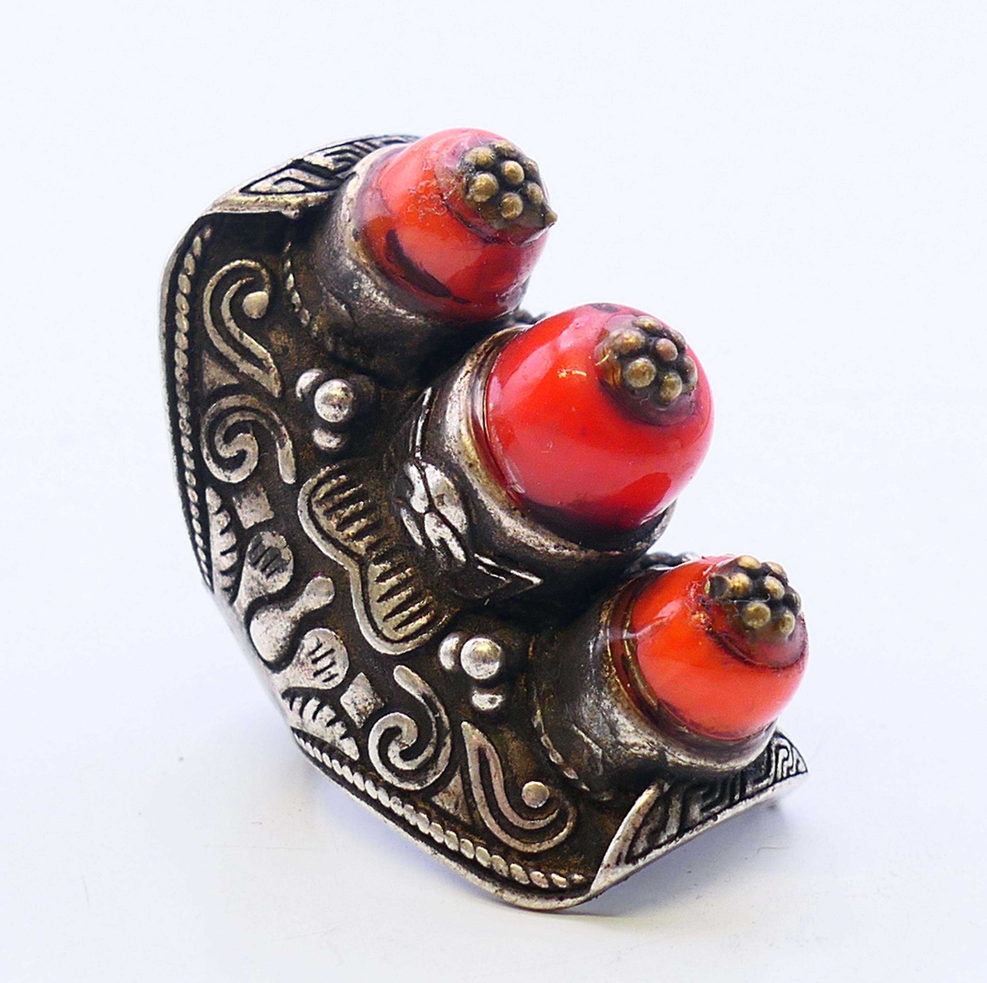 A Tibetan white metal coral ring. Ring size S.