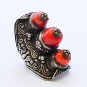 A Tibetan white metal coral ring. Ring size S.