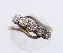 An 18 ct gold five stone diamond ring. Ring size O.