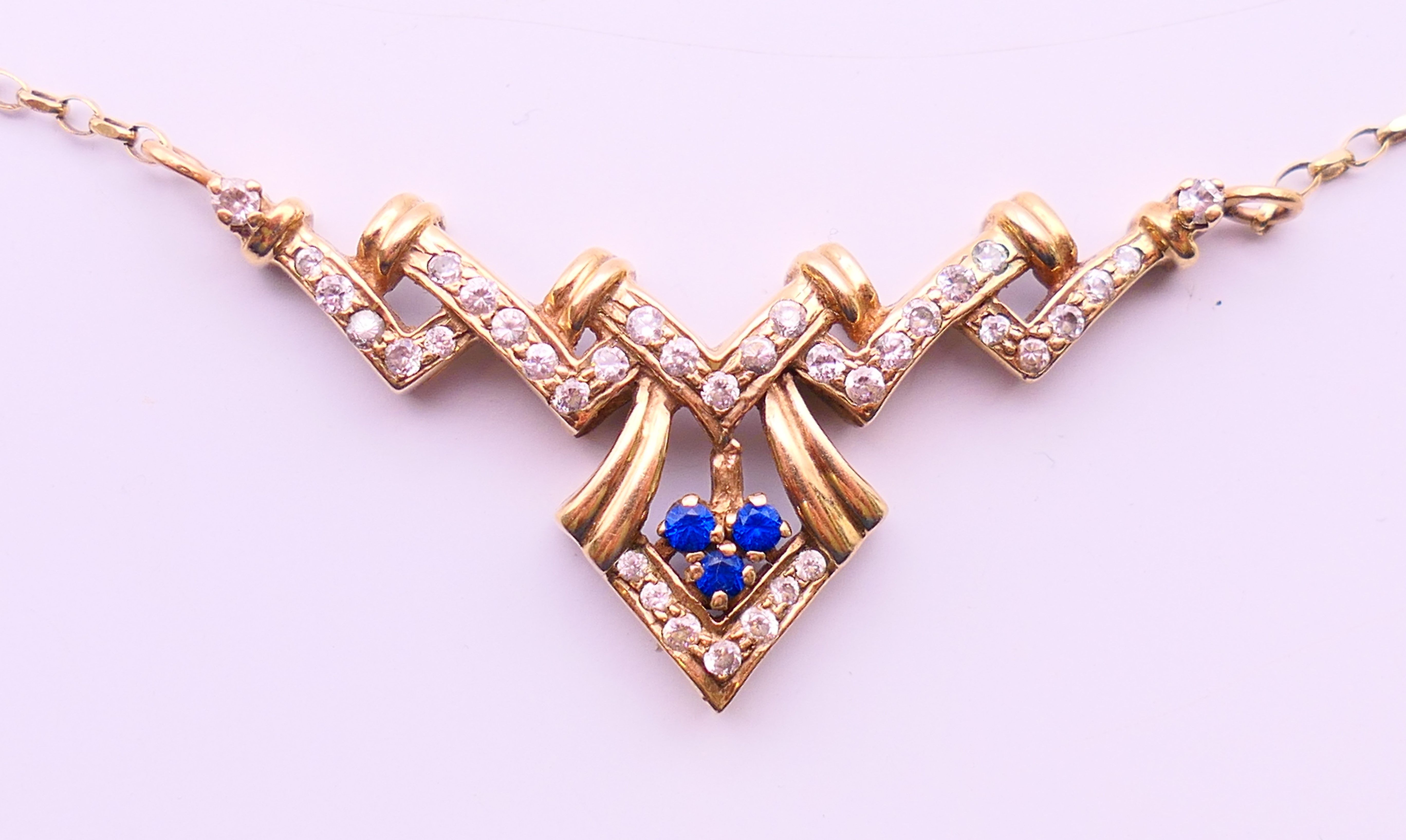 A 9 ct gold Art Deco style necklace. Approximately 42 cm long. 6 grammes total weight.