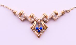 A 9 ct gold Art Deco style necklace. Approximately 42 cm long. 6 grammes total weight.