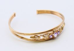 A 9 ct gold bracelet. 6 cm diameter. 6.4 grammes total weight.