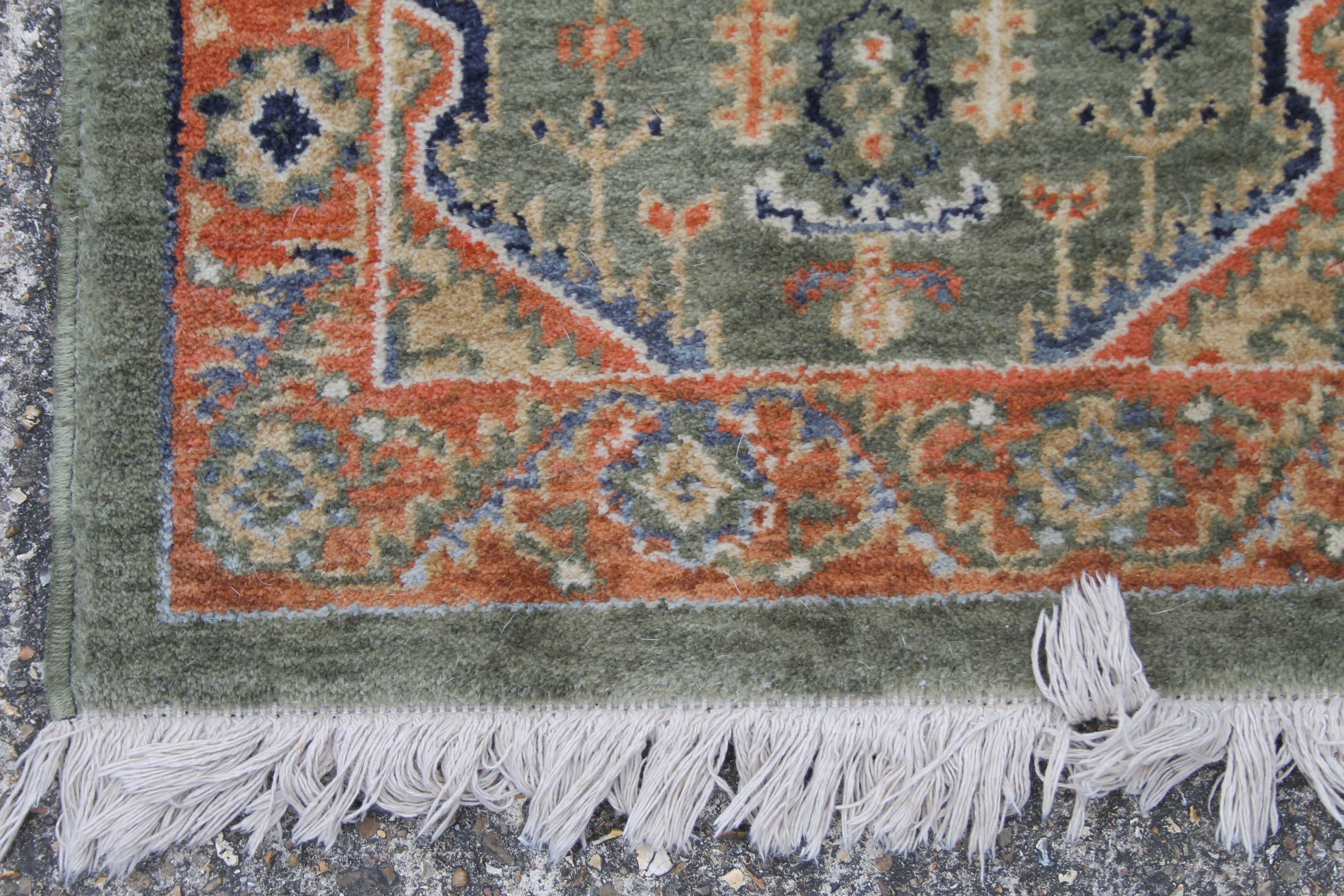 A small green ground rug. 60 x 95 cm. - Image 2 of 3