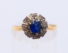 An 18 ct gold and platinum diamond and sapphire ring. Ring size L.