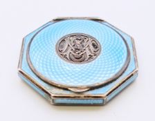 A silver and blue enamel compact. 6 cm diameter.