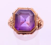 An unmarked gold and amethyst ring. Ring size L/M.