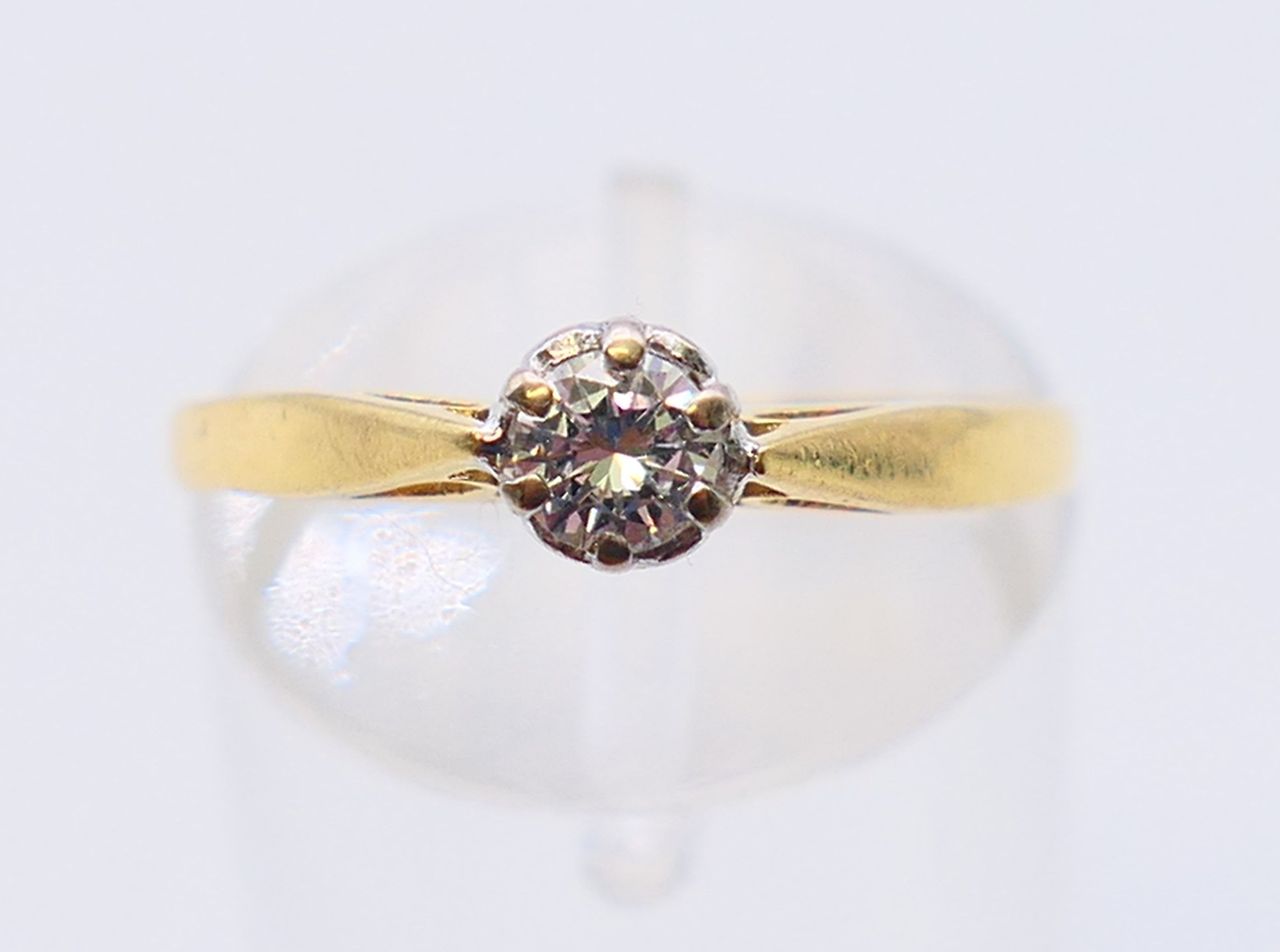 An 18 ct gold diamond solitaire ring. Ring size N.