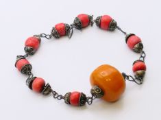 A tribal coral and amber necklace. 48 cm long.