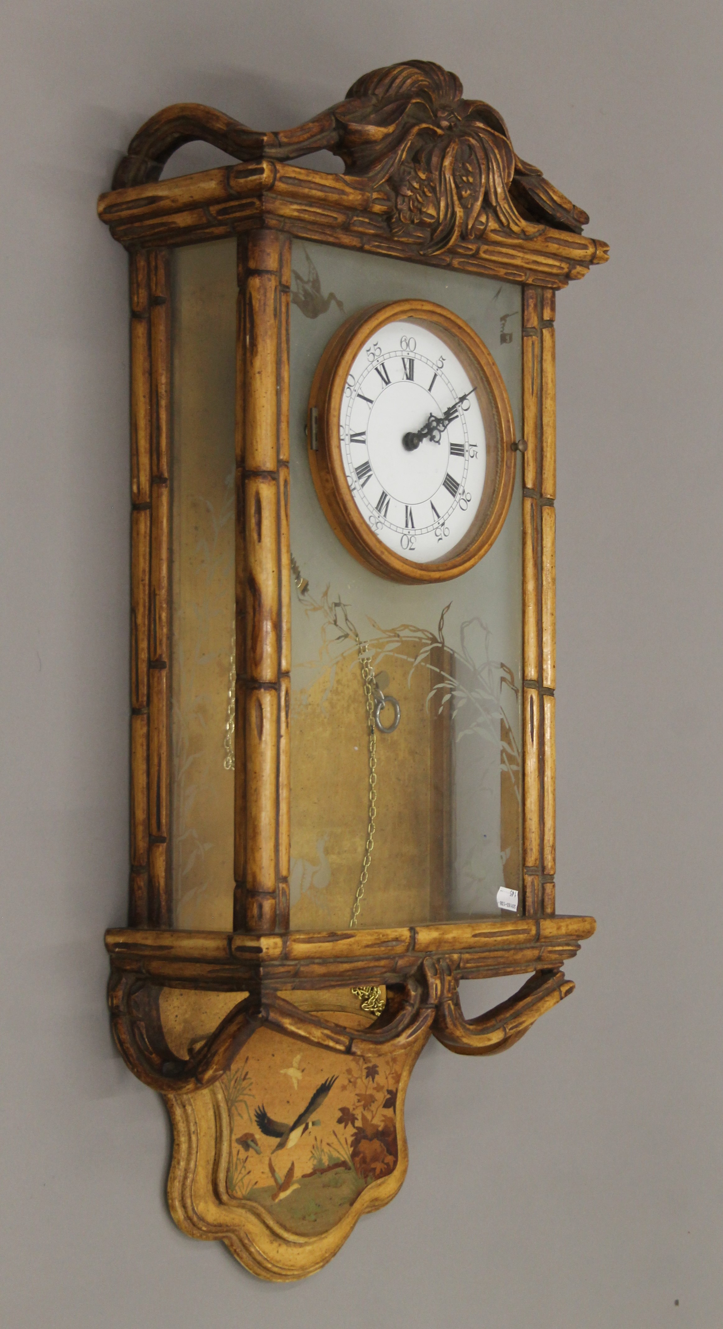 An Art Nouveau-style wall clock. 90 cm high.