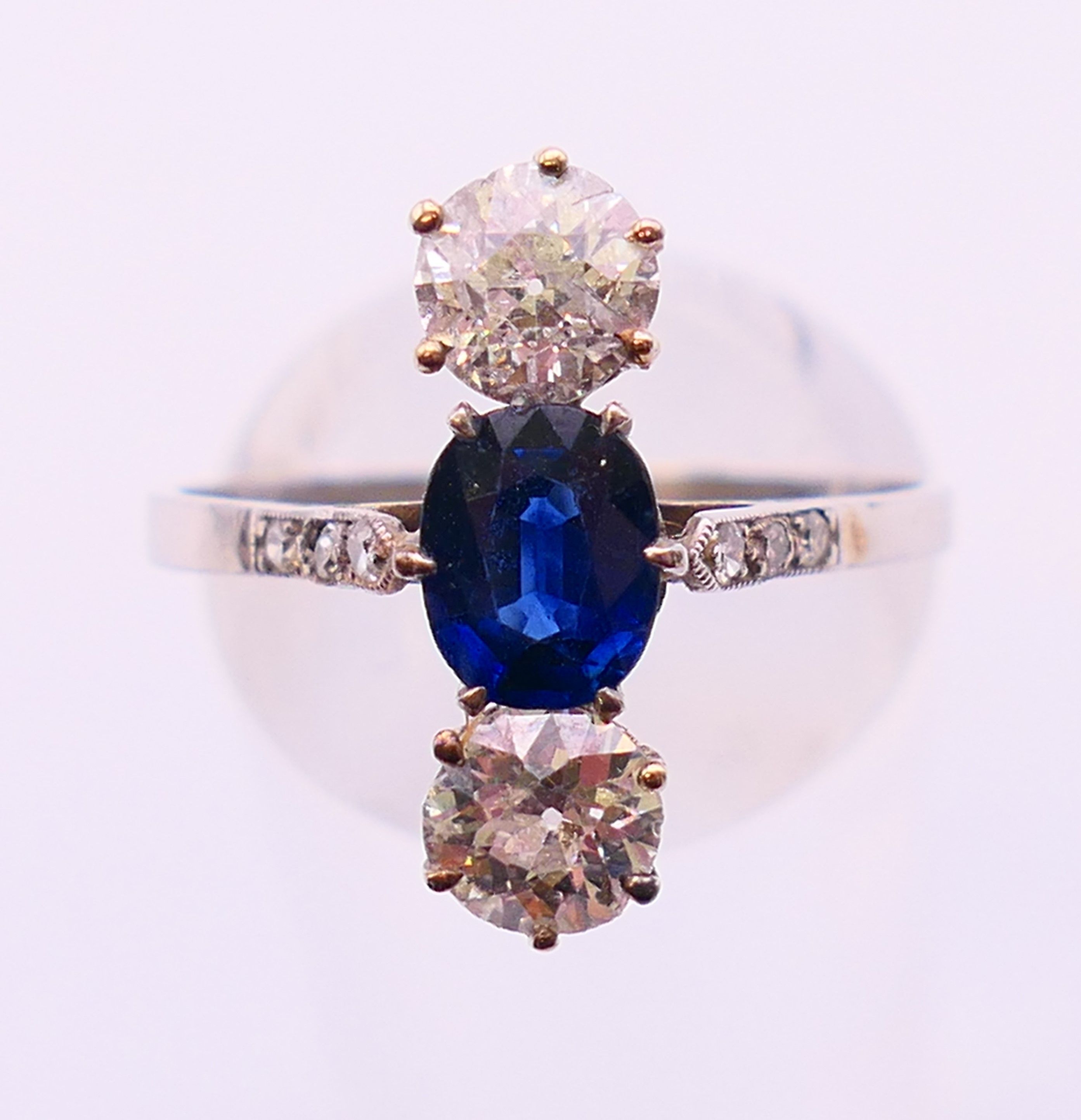 A three stone diamond and sapphire ring. Ring size R.