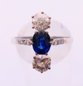 A three stone diamond and sapphire ring. Ring size R.