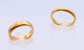 Two 22 ct wedding bands, one inscribed to the inner band IGS and ?18th Novr 1975.