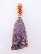 An 18 ct gold, ruby and amethyst pendant. Pendant 6.5 cm high.
