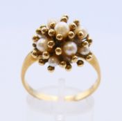 A 9 ct gold and pearl ring. Rings size V.