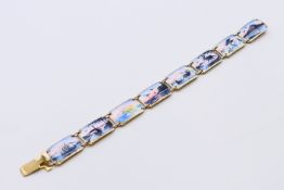 A Scandinavian silver and enamel eight-panel bracelet. 17 cm long.
