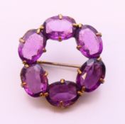 An amethyst brooch. 2.5 cm diameter.