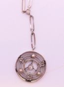 A diamond set pendant on chain. Pendant 1.8 cm diameter, chain 42 cm long.