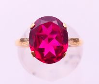 A 9 ct gold and synthetic ruby ring. 3.35 grammes total weight. Ring size N.