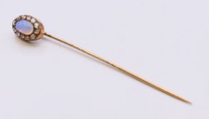 A stick pin set with an opal, the box with Genuine Hasaldo Mine Stone inscription. 7.