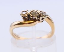 A 9 ct yellow gold three stone diamond ring. Head size approximately 10mm x 4mm, ring size J/K.
