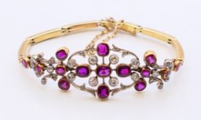 A gold, possibly 15 ct ruby and diamond bracelet. Approximately 17 cm long.