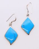 A pair of silver and turquoise earrings. 2.5 cm high.