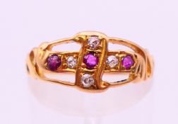 A gold, ruby and diamond ring. Ring size M.