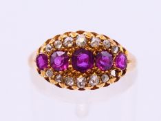 An 18 ct gold five-stone ruby and diamond ring. Ring size N.