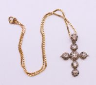 A Victorian diamond set cross pendant on chain.