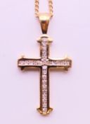 A 9 ct yellow gold diamond cross with twenty-six diamonds on a 9 ct yellow gold chain.