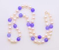 A lavender jade and pearl necklace with 18 ct gold clasp. 44 cm long.