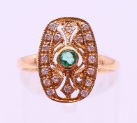 A 9 ct yellow gold Art Deco style diamond and emerald ring.