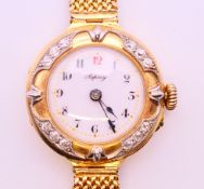 An Asprey 18 ct gold cased and diamond lady's wristwatch with 15 ct gold mesh strap. 2.