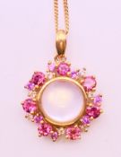 A 9 ct yellow gold tourmaline and moonstone pendant on a 9 ct yellow gold chain.