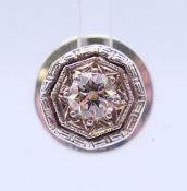 A 14 ct white gold and diamond lapel pin/stud pin. Head size approximately 9mm diameter.