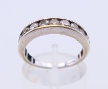 A 9 ct white gold half hoop eternity ring. Ring size M/N.