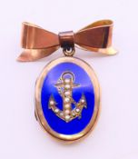 A blue enamel and seed pearl anchor motif locket with bow-form brooch clip. Locket 2.5 cm high, 3.