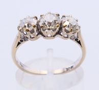 An 18 ct white gold three stone old cut diamond ring, approximately 1.65 carats of diamonds.